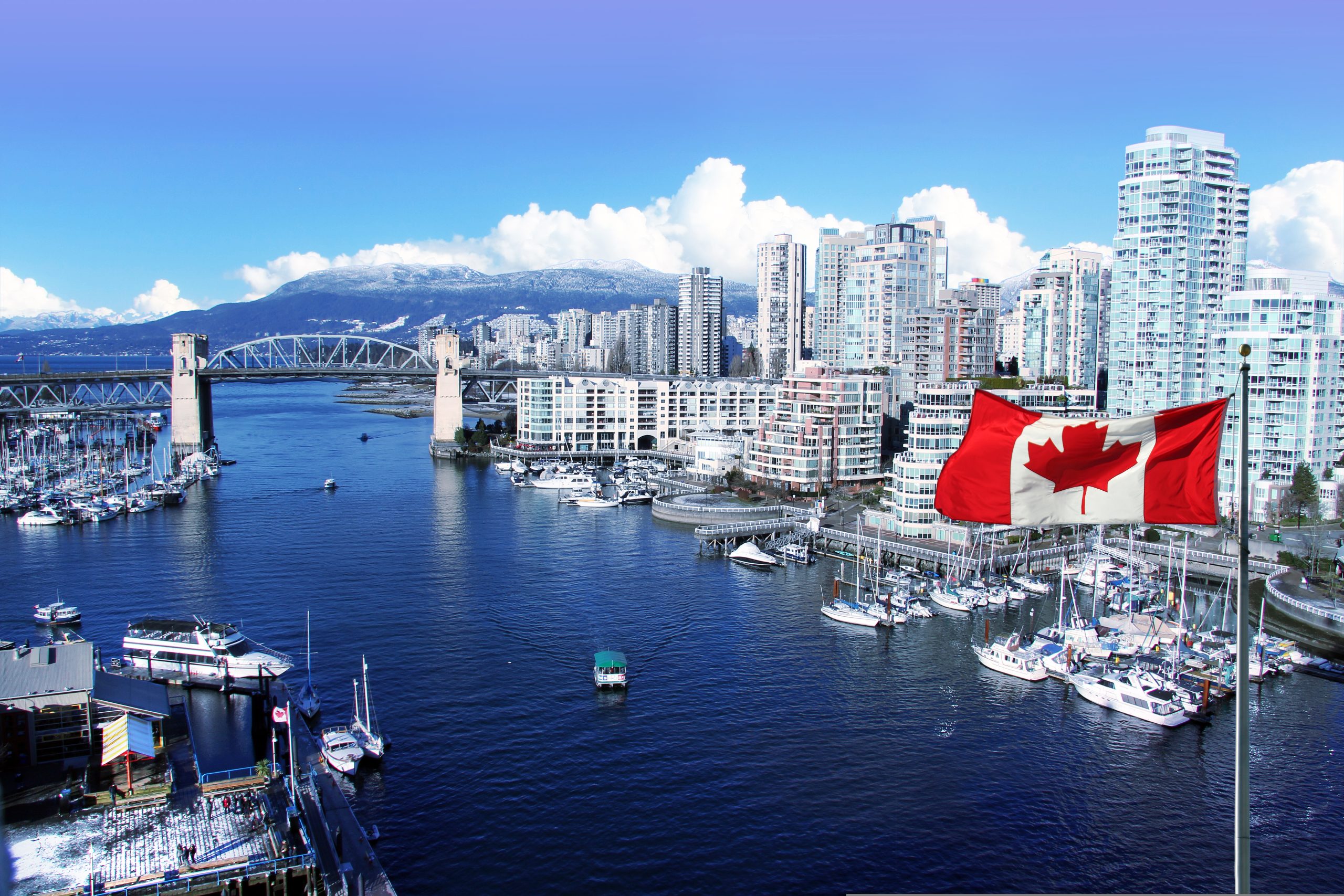 Canadian,Flag,In,Front,Of,View,Of,False,Creek,And