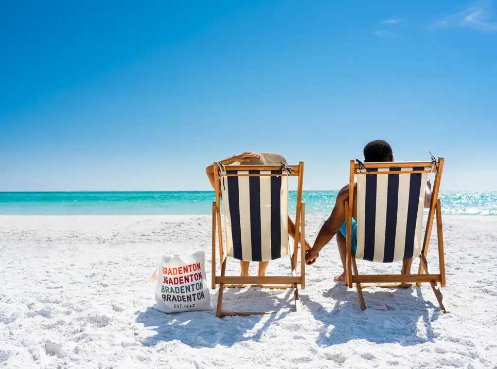 BACVB Photoshoot Couple Handholding Bradenton Bag on Beach bradenton